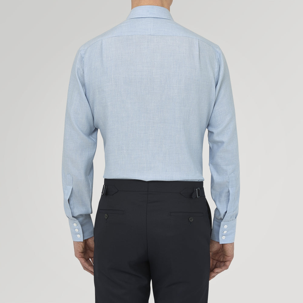 The Turnbull & Asser Blue Cashmere Blend Shirt features a T&A collar and 3-button cuffs, elegantly folded and showcased against a plain white background.