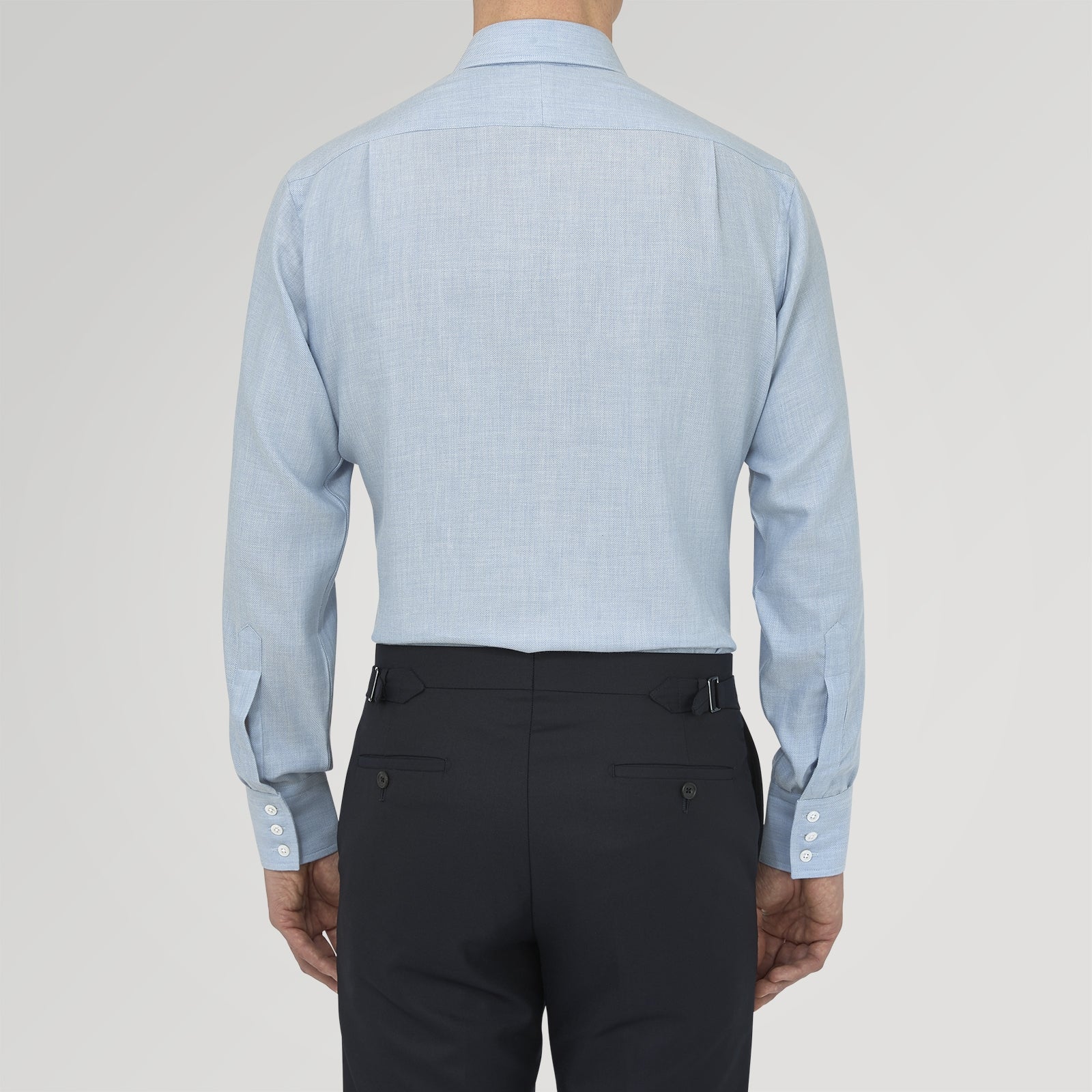 View 3 of product The Turnbull & Asser Blue Cashmere Blend Shirt features a T&A collar and 3-button cuffs, elegantly folded and showcased against a plain white background.