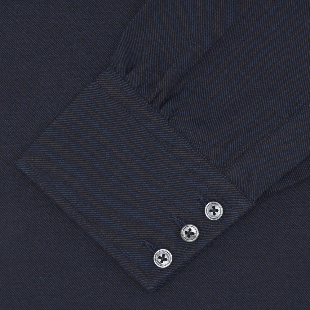A navy cashmere blend Turnbull & Asser shirt with a T&A collar and 3-button cuffs, neatly folded and displayed against a plain white background.