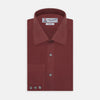 View 1 of product The Turnbull & Asser Burgundy Silk Shirt features a T&A collar and 3-button cuffs, offering a refined alternative to a black tie for modern style. Displayed folded on a white background.