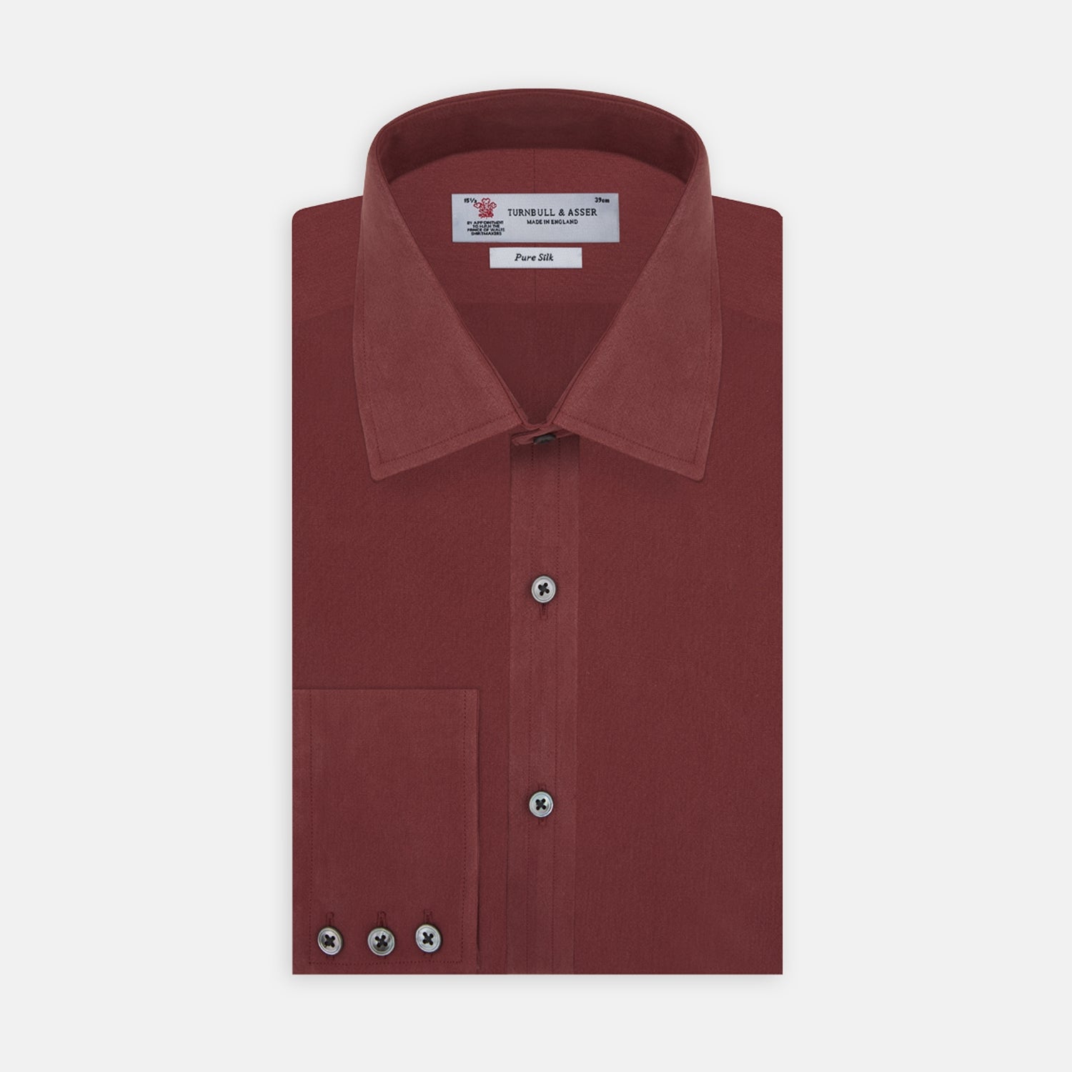 View 1 of product The Turnbull & Asser Burgundy Silk Shirt features a T&A collar and 3-button cuffs, offering a refined alternative to a black tie for modern style. Displayed folded on a white background.