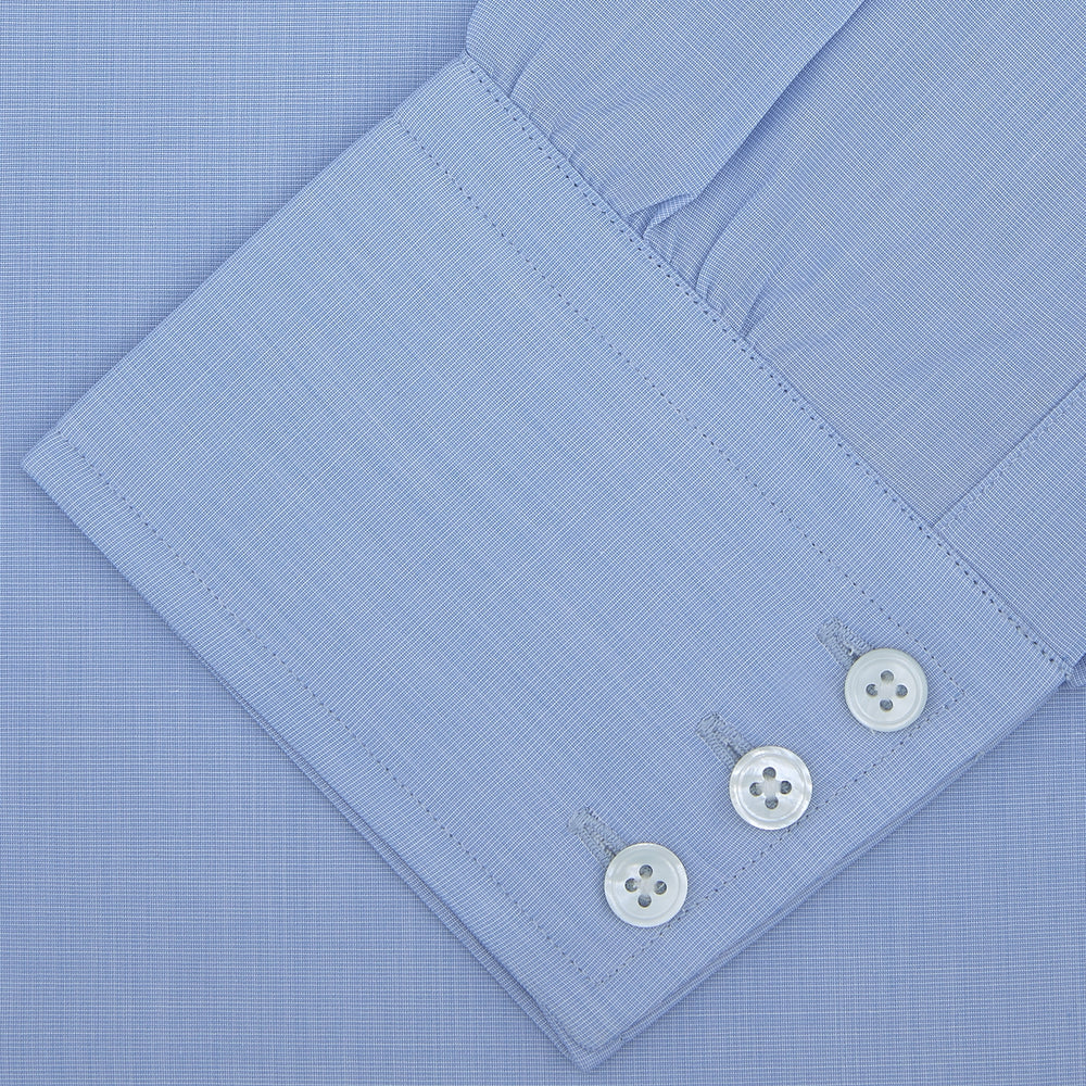 The Turnbull & Asser Light Blue End On End Shirt with Regent Collar and 3 Button Cuffs is shown neatly folded on a white background, featuring a visible chest pocket and brand label inside the collar.