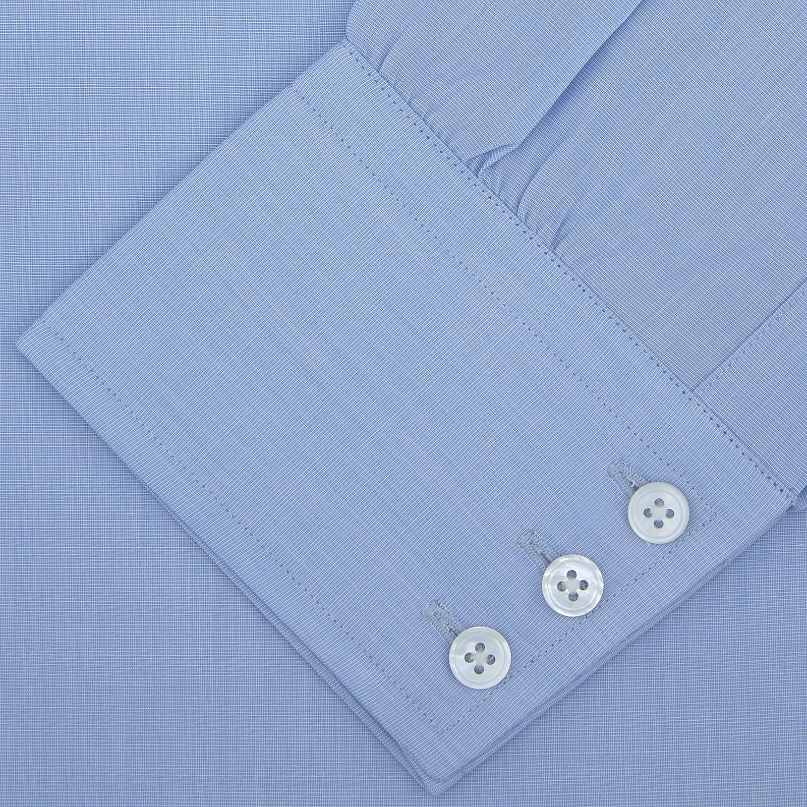 View 4 of product The Turnbull & Asser Light Blue End On End Shirt with Regent Collar and 3 Button Cuffs is shown neatly folded on a white background, featuring a visible chest pocket and brand label inside the collar.