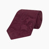 View 1 of product The Turnbull & Asser Burgundy Paisley Silk Tie, showcased rolled on a white background, is an elegant statement piece featuring a refined paisley design for any wardrobe.
