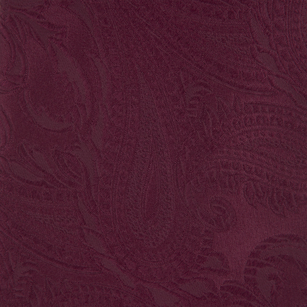 The Turnbull & Asser Burgundy Paisley Silk Tie, showcased rolled on a white background, is an elegant statement piece featuring a refined paisley design for any wardrobe.