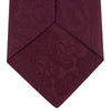 View 4 of product The Turnbull & Asser Burgundy Paisley Silk Tie, showcased rolled on a white background, is an elegant statement piece featuring a refined paisley design for any wardrobe.