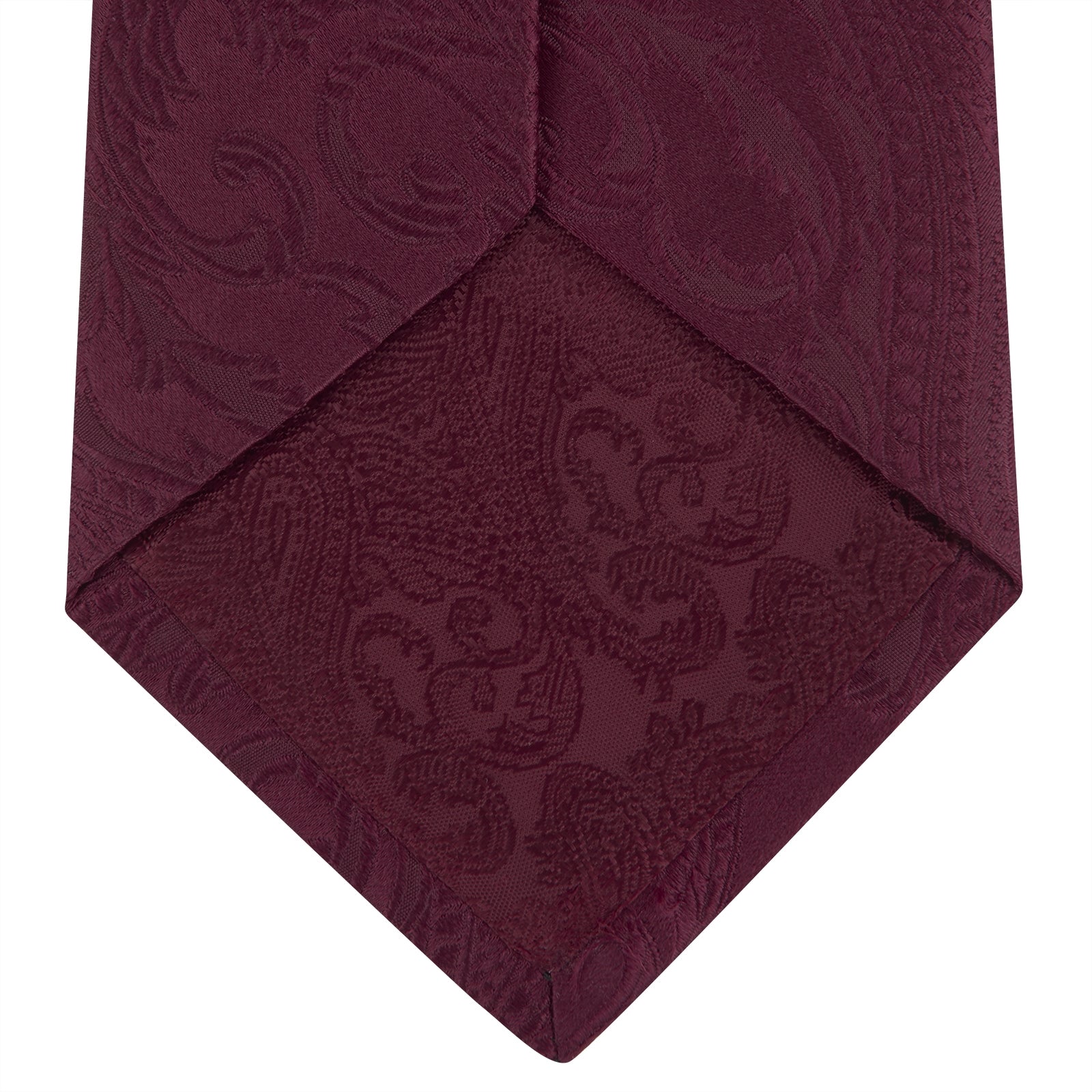 View 4 of product The Turnbull & Asser Burgundy Paisley Silk Tie, showcased rolled on a white background, is an elegant statement piece featuring a refined paisley design for any wardrobe.