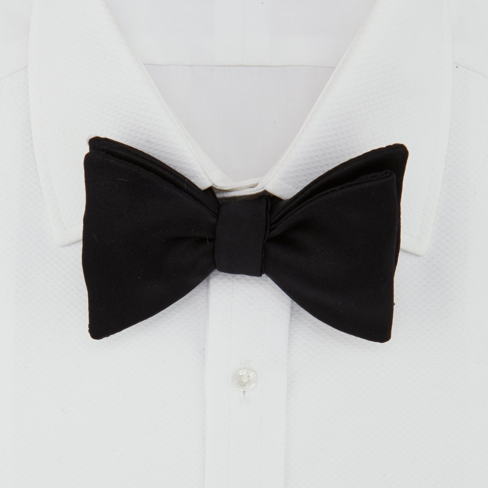 View 2 of product The Turnbull & Asser Black Satin Bow Tie features a classic, neatly tied shape, displayed on a white background—a sophisticated accessory for formal attire.