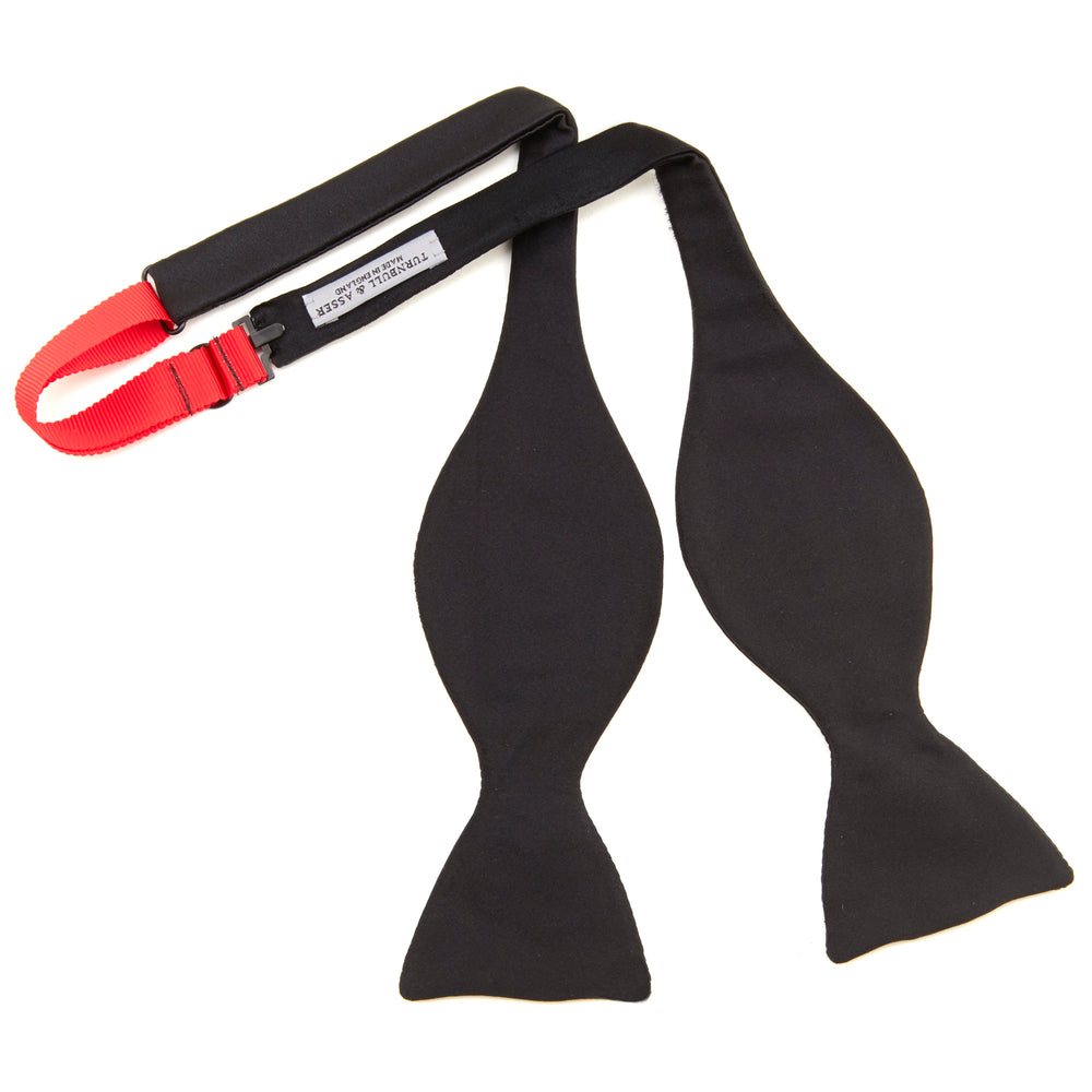 The Turnbull & Asser Black Satin Bow Tie features a classic, neatly tied shape, displayed on a white background—a sophisticated accessory for formal attire.