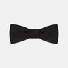 View 1 of product The Black Narrow Silk Bow Tie by Turnbull & Asser features a classic slim design with a matte finish, neatly tied and centered on a plain white background—perfect for formal occasions.