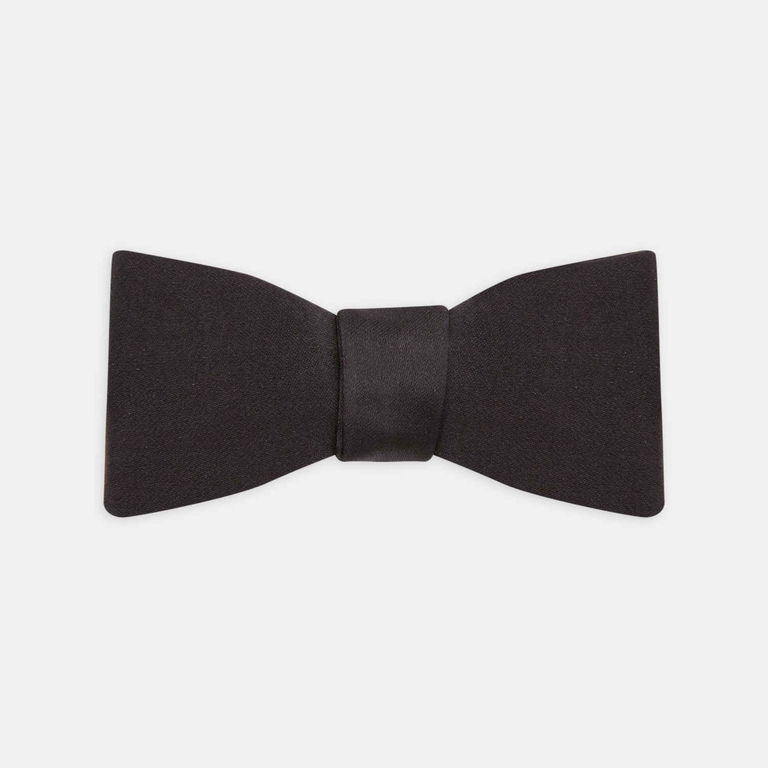 View 1 of product The Turnbull & Asser Black Silk Bow Tie features a matte finish and classic design, ideal for formal occasions. Shown pre-tied against a plain white background.