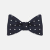 View 1 of product The Winston Navy and White Spot Silk Bow Tie by Turnbull & Asser features classic white polka dots on navy silk, reminiscent of Winston Churchill's style, and is shown against a plain white background.