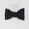 View 2 of product The Winston Navy and White Spot Silk Bow Tie by Turnbull & Asser features classic white polka dots on navy silk, reminiscent of Winston Churchill's style, and is shown against a plain white background.