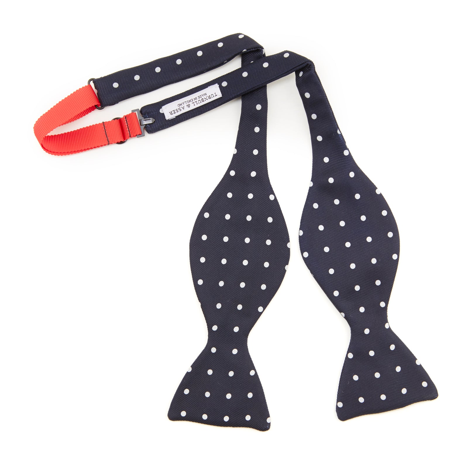 View 3 of product The Winston Navy and White Spot Silk Bow Tie by Turnbull & Asser features classic white polka dots on navy silk, reminiscent of Winston Churchill's style, and is shown against a plain white background.