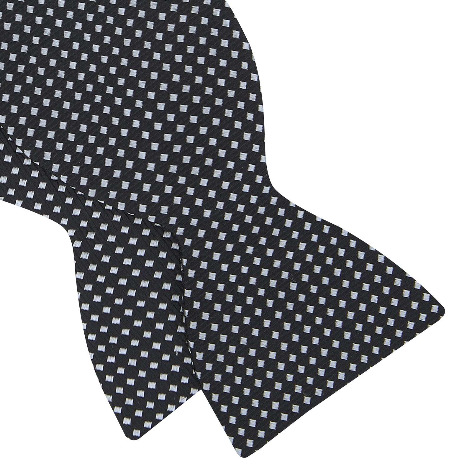 View 4 of product The Turnbull & Asser Diamond Black and White Silk Bow Tie features a black woven silk design with a tessellated diamond pattern of small white shapes, shown against a plain white background.