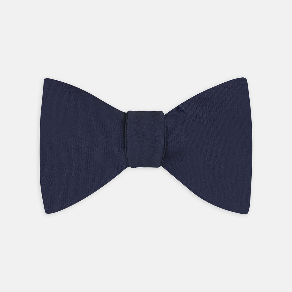 The Turnbull & Asser Navy Satin Silk Bow Tie is elegantly showcased against a plain white background.