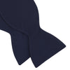 View 4 of product The Turnbull & Asser Navy Satin Silk Bow Tie is elegantly showcased against a plain white background.
