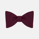 The Turnbull & Asser Burgundy Barathea Bow Tie, shown neatly tied with pointed ends on a white background, features smooth matte fabric for a refined formal look.
