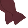 View 4 of product The Turnbull & Asser Burgundy Barathea Bow Tie, shown neatly tied with pointed ends on a white background, features smooth matte fabric for a refined formal look.