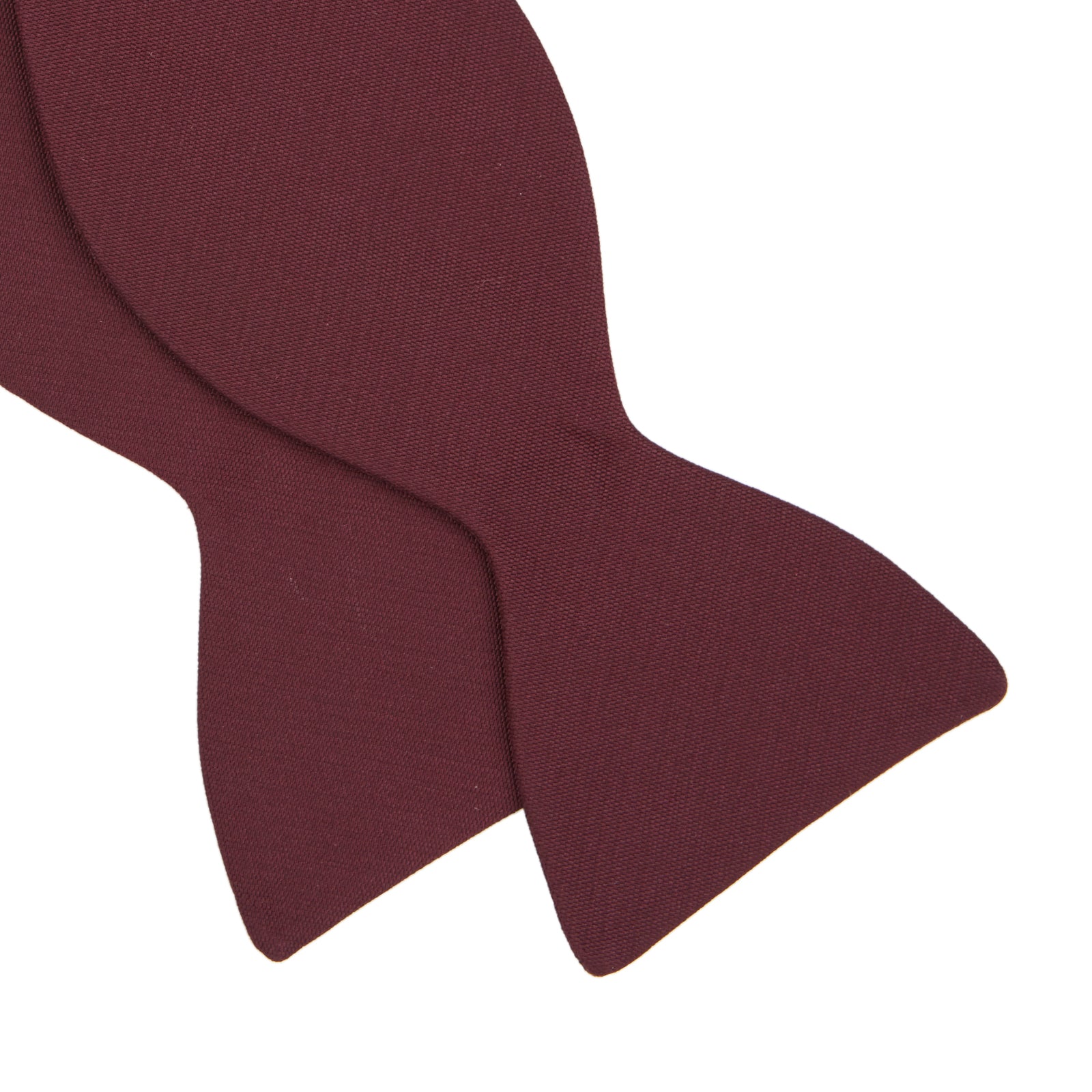 View 4 of product The Turnbull & Asser Burgundy Barathea Bow Tie, shown neatly tied with pointed ends on a white background, features smooth matte fabric for a refined formal look.