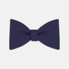 View 1 of product The Turnbull & Asser Navy Barathea Bow Tie features a classic butterfly shape in deep blue silk, ideal for formal occasions, shown against a white background.