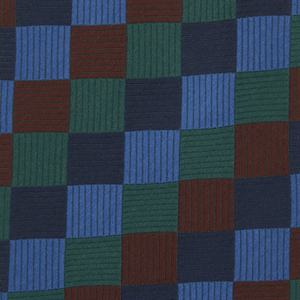 The Turnbull & Asser Navy and Blue Checkerboard Jacquard Wool Tie showcases a stylish checkered pattern, ideal for adding refined autumn tones to your ensemble.