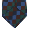 View 4 of product The Turnbull & Asser Navy and Blue Checkerboard Jacquard Wool Tie showcases a stylish checkered pattern, ideal for adding refined autumn tones to your ensemble.