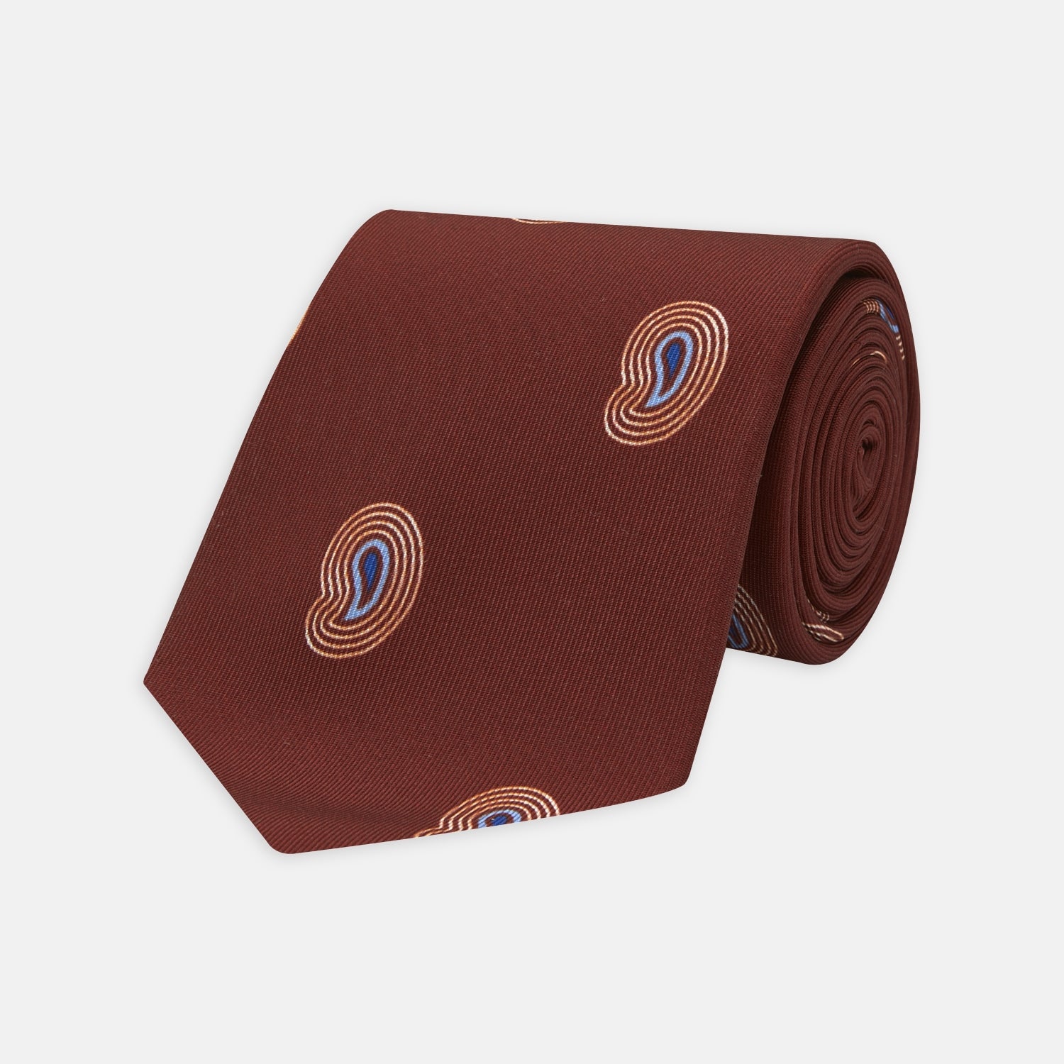 View 1 of product The Turnbull & Asser Red Pulse Paisley Silk Tie features a rolled red silk design with a repeating pattern of tan, blue, and white abstract pulse motifs.