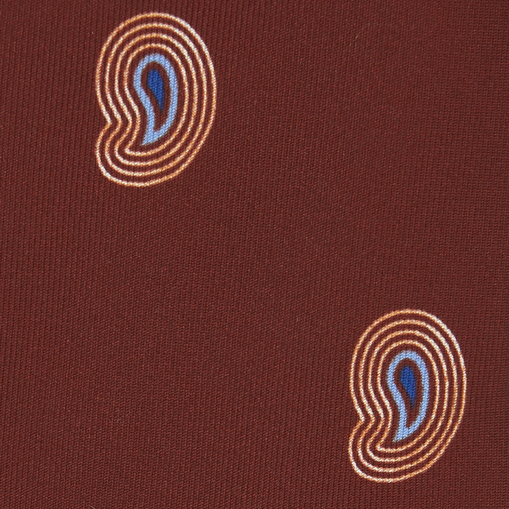 The Turnbull & Asser Red Pulse Paisley Silk Tie features a rolled red silk design with a repeating pattern of tan, blue, and white abstract pulse motifs.