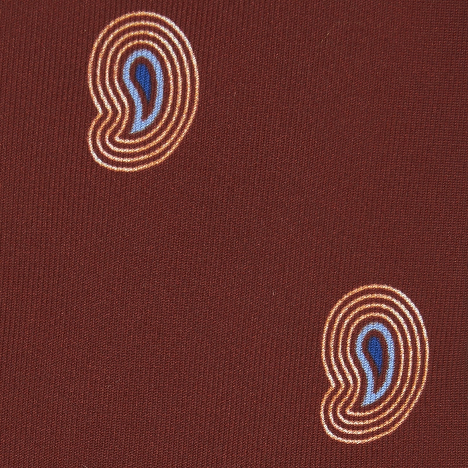 View 3 of product The Turnbull & Asser Red Pulse Paisley Silk Tie features a rolled red silk design with a repeating pattern of tan, blue, and white abstract pulse motifs.