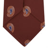 View 4 of product The Turnbull & Asser Red Pulse Paisley Silk Tie features a rolled red silk design with a repeating pattern of tan, blue, and white abstract pulse motifs.