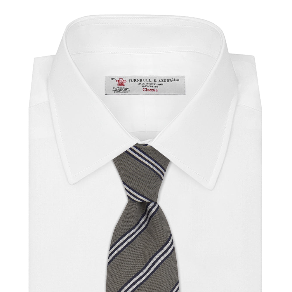 The Turnbull & Asser Grey Diagonal Stripe Cotton and Silk Tie features a navy, grey, and white striped pattern and is shown rolled up against a plain white background.
