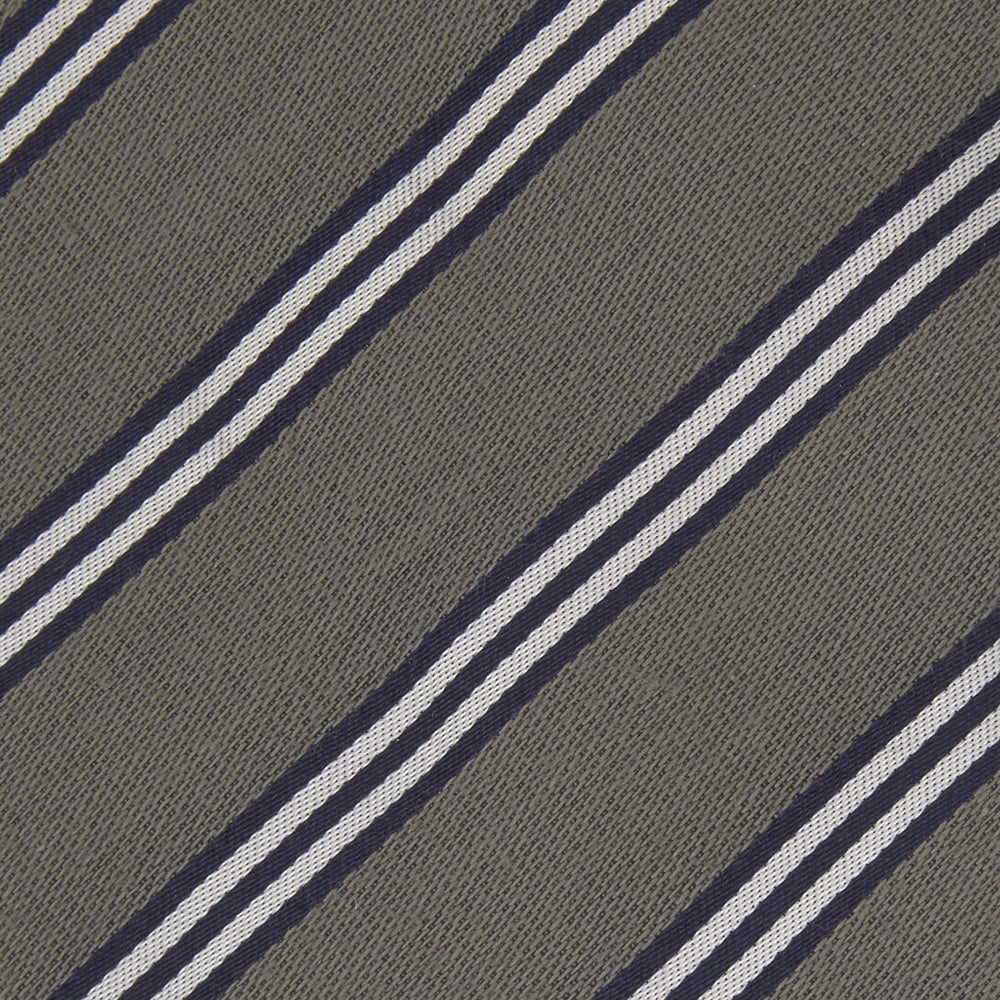 The Turnbull & Asser Grey Diagonal Stripe Cotton and Silk Tie features a navy, grey, and white striped pattern and is shown rolled up against a plain white background.