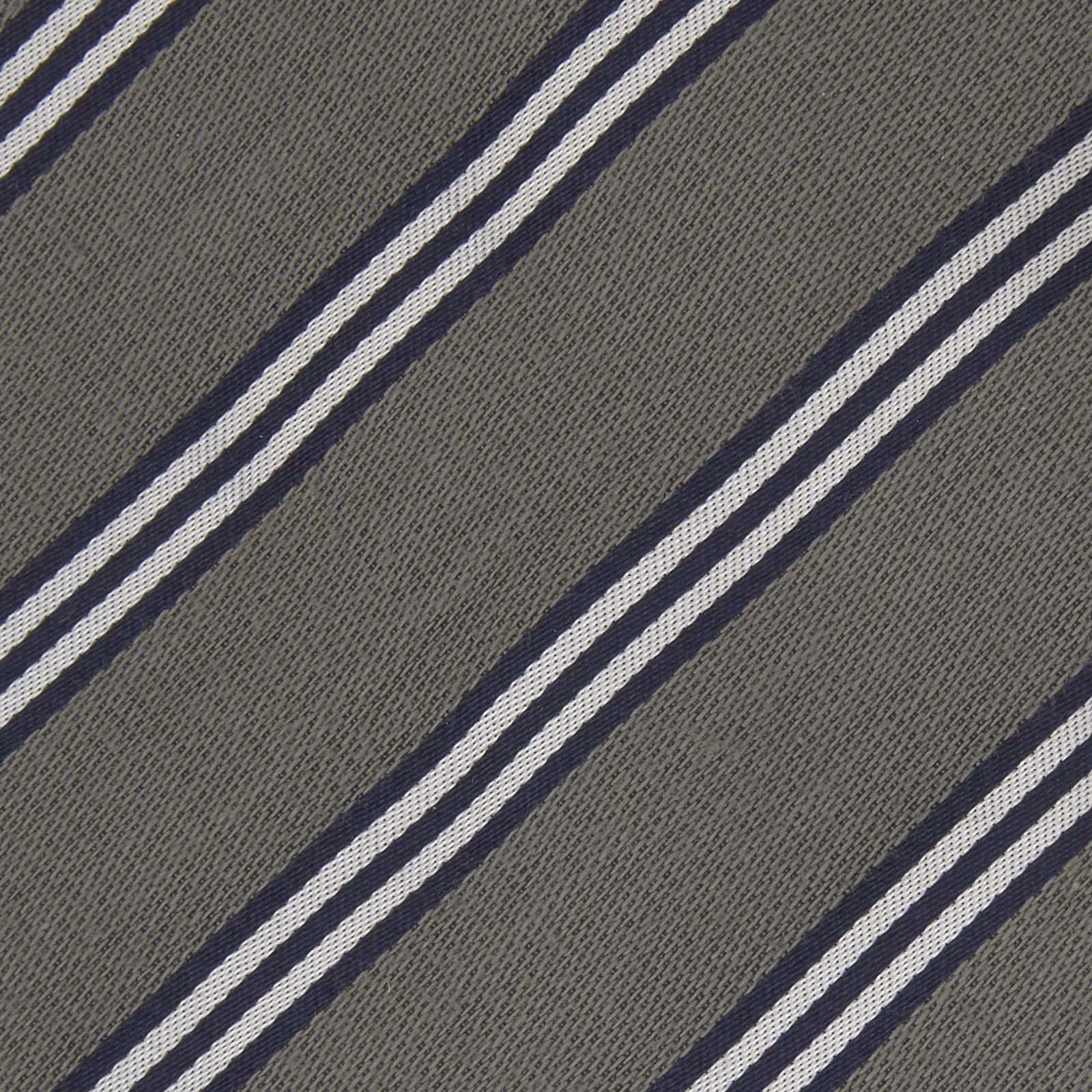 View 3 of product The Turnbull & Asser Grey Diagonal Stripe Cotton and Silk Tie features a navy, grey, and white striped pattern and is shown rolled up against a plain white background.