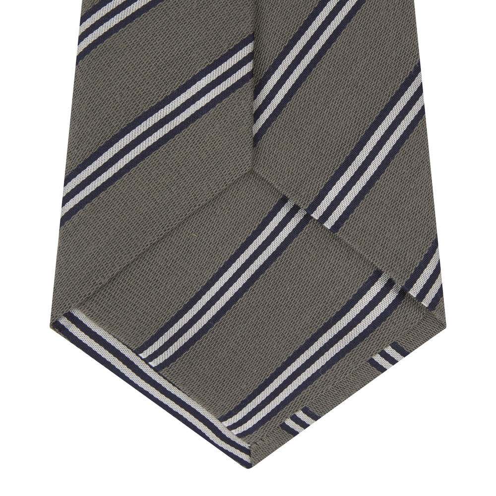 The Turnbull & Asser Grey Diagonal Stripe Cotton and Silk Tie features a navy, grey, and white striped pattern and is shown rolled up against a plain white background.