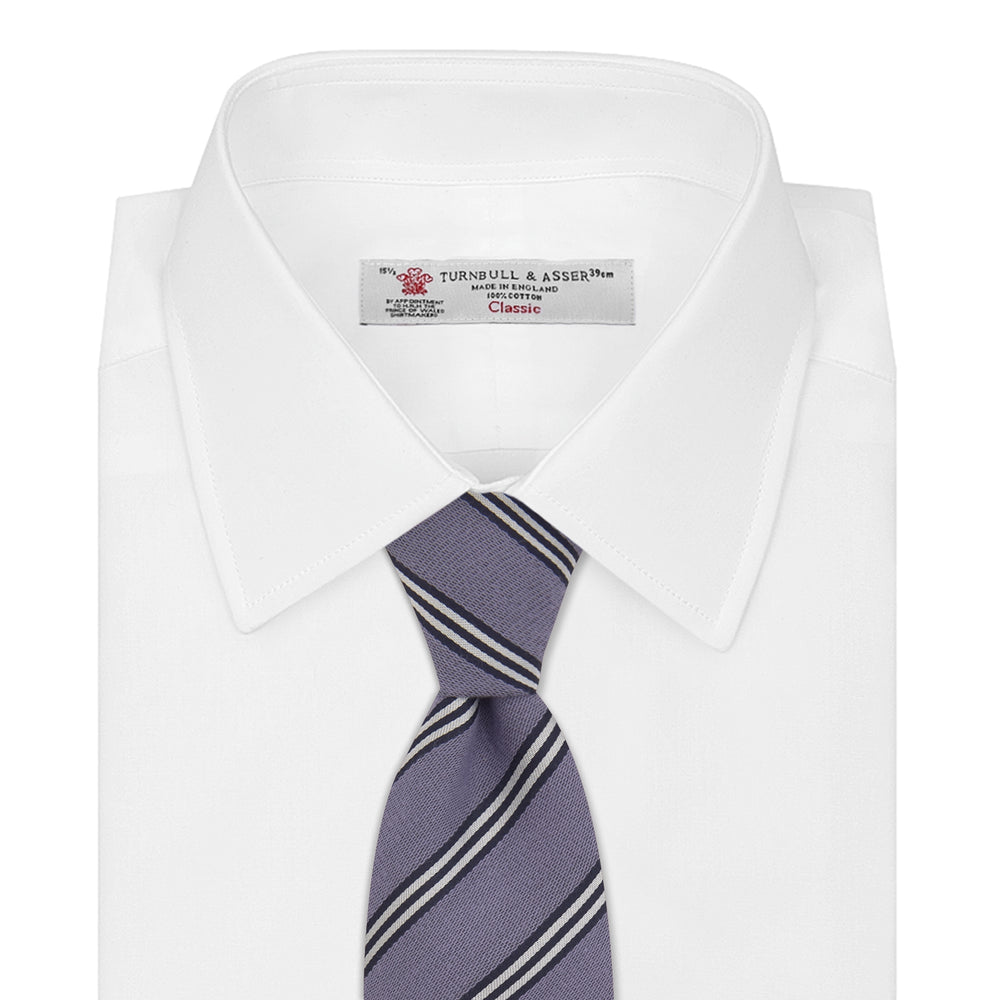 The Turnbull & Asser Lilac Diagonal Stripe Cotton and Silk Tie features classic black and white stripes, shown neatly rolled on a white background.