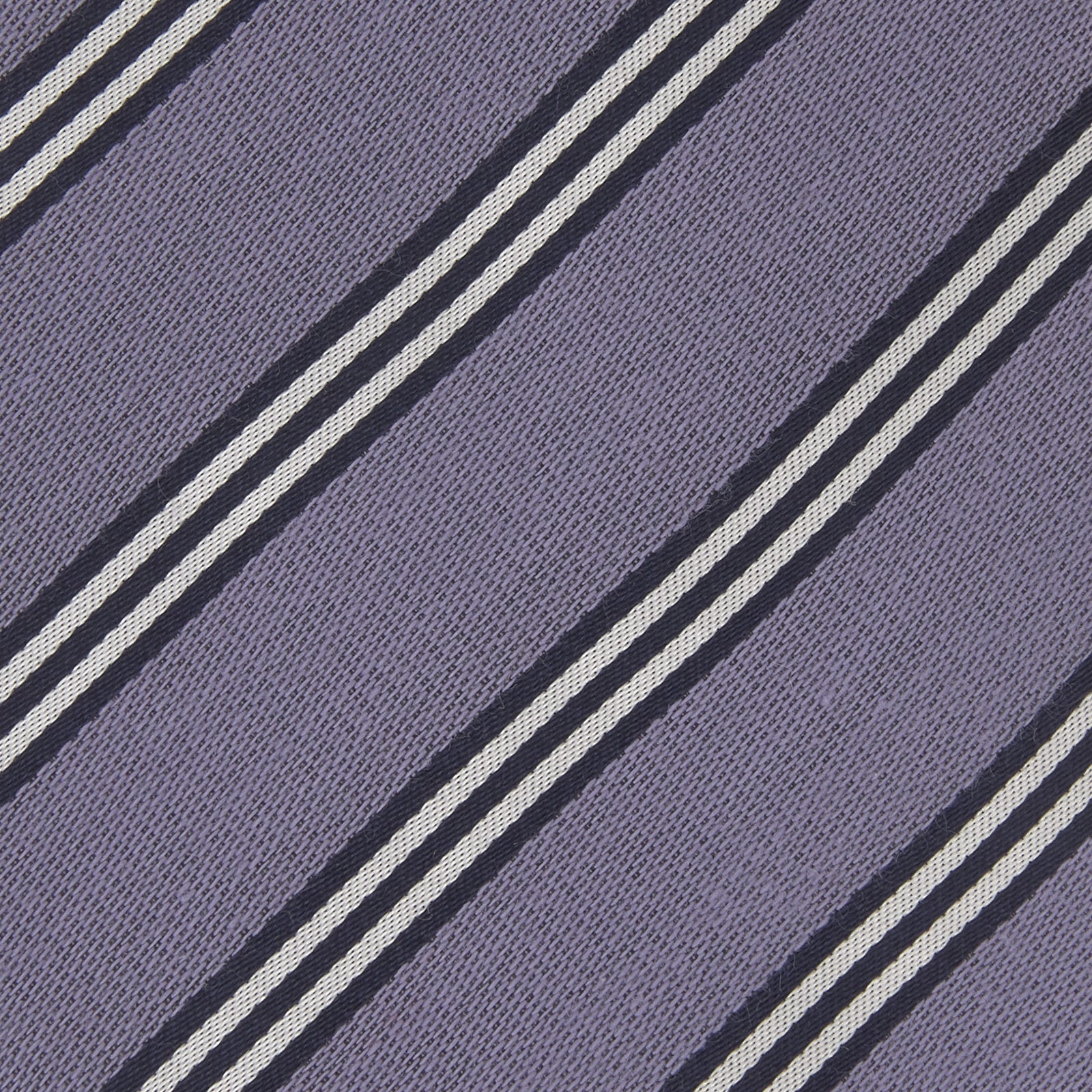 View 3 of product The Turnbull & Asser Lilac Diagonal Stripe Cotton and Silk Tie features classic black and white stripes, shown neatly rolled on a white background.