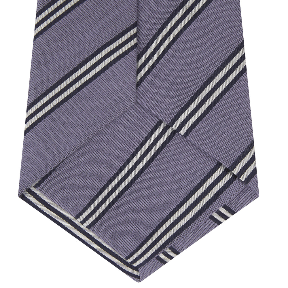 The Turnbull & Asser Lilac Diagonal Stripe Cotton and Silk Tie features classic black and white stripes, shown neatly rolled on a white background.