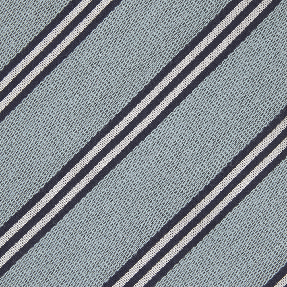 The Turnbull & Asser Powder Blue Diagonal Stripe Cotton and Silk Tie, featuring navy and white club stripes, is shown rolled up on a plain white background.
