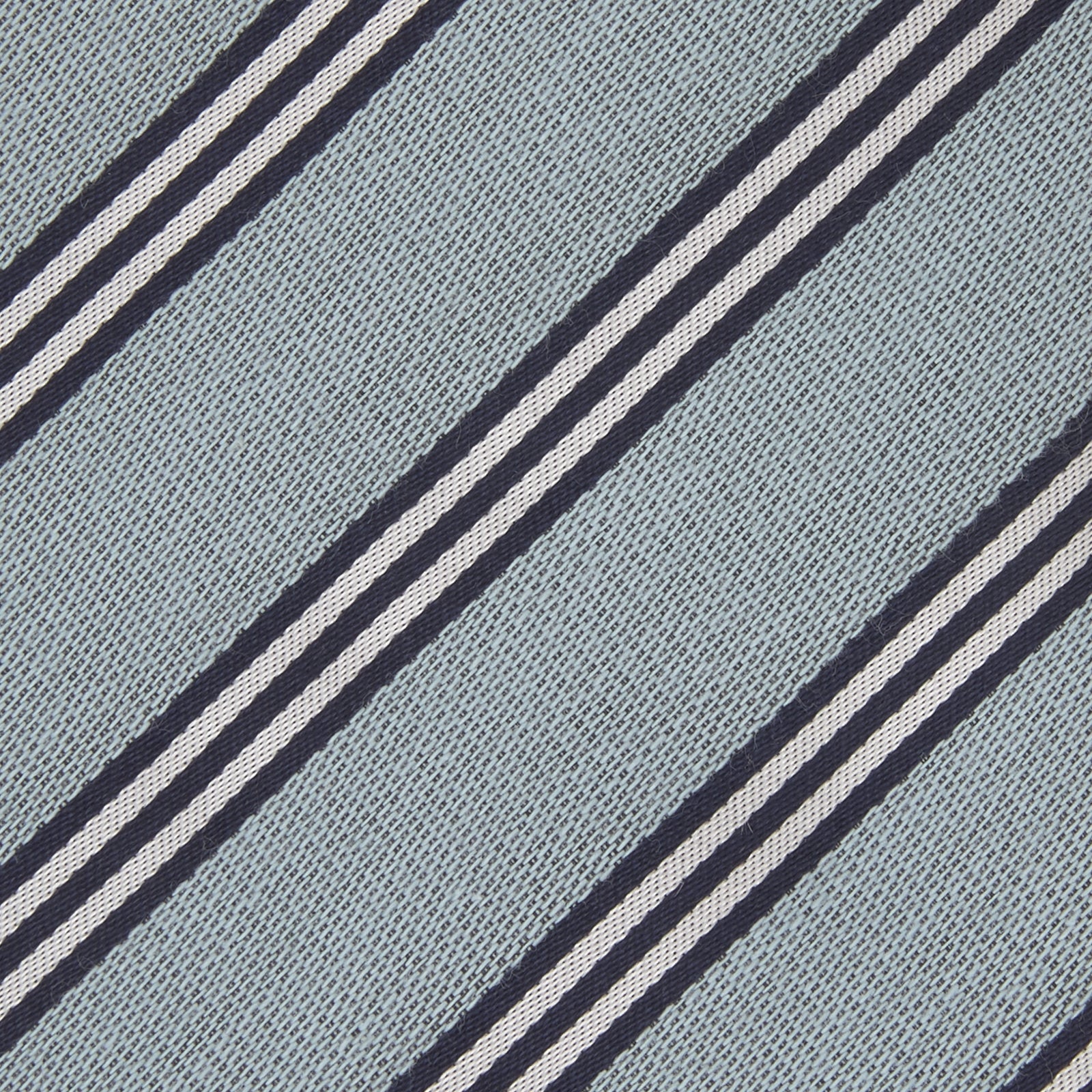 View 3 of product The Turnbull & Asser Powder Blue Diagonal Stripe Cotton and Silk Tie, featuring navy and white club stripes, is shown rolled up on a plain white background.