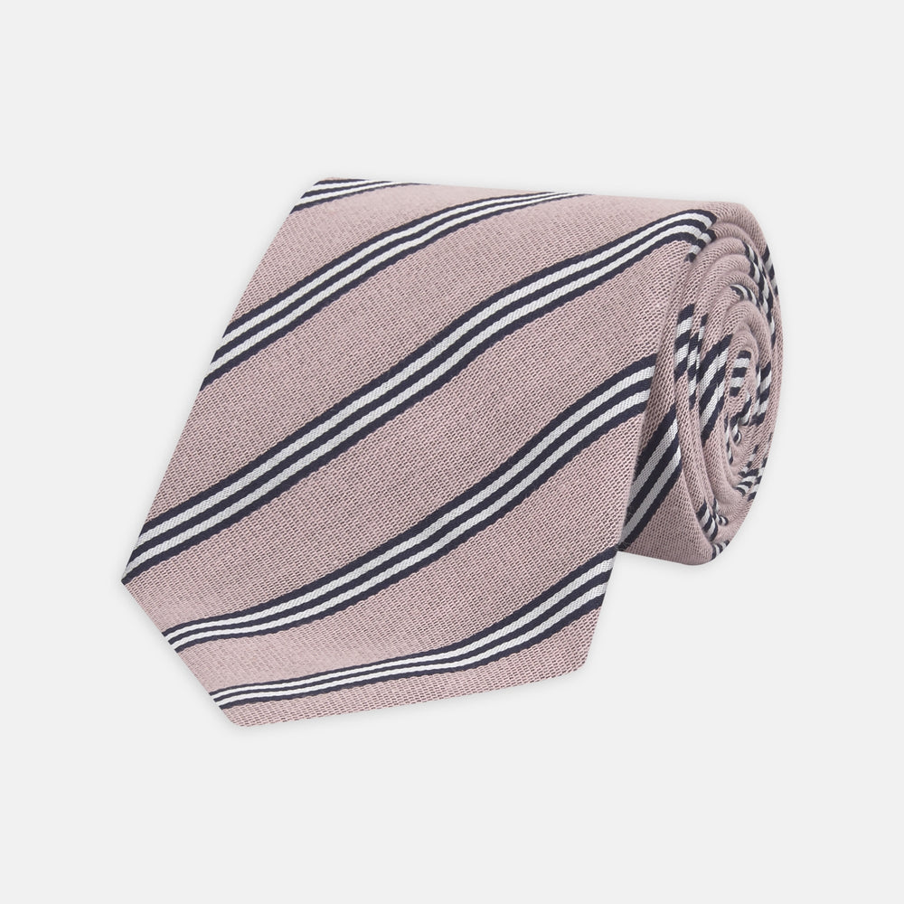 The Turnbull & Asser Pastel Pink Diagonal Stripe Cotton and Silk Tie, featuring navy blue and white stripes, is neatly rolled against a plain white background.