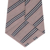 View 4 of product The Turnbull & Asser Pastel Pink Diagonal Stripe Cotton and Silk Tie, featuring navy blue and white stripes, is neatly rolled against a plain white background.