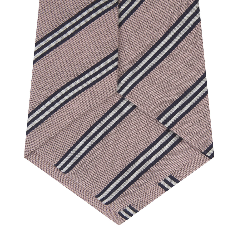 The Turnbull & Asser Pastel Pink Diagonal Stripe Cotton and Silk Tie, featuring navy blue and white stripes, is neatly rolled against a plain white background.