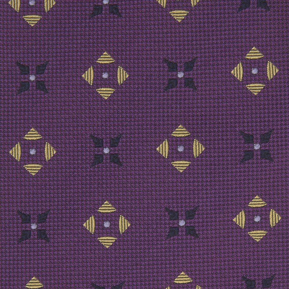 The Turnbull & Asser Purple Crosses Silk Tie features a rolled-up purple design with small yellow and black cross motifs on silk.