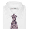 View 2 of product The Turnbull & Asser Pink Floral Occasion Silk Tie features a rolled-up purple jacquard design with a light pink floral pattern, perfect for weddings or floral events, shown on a plain white background.
