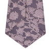 View 4 of product The Turnbull & Asser Pink Floral Occasion Silk Tie features a rolled-up purple jacquard design with a light pink floral pattern, perfect for weddings or floral events, shown on a plain white background.