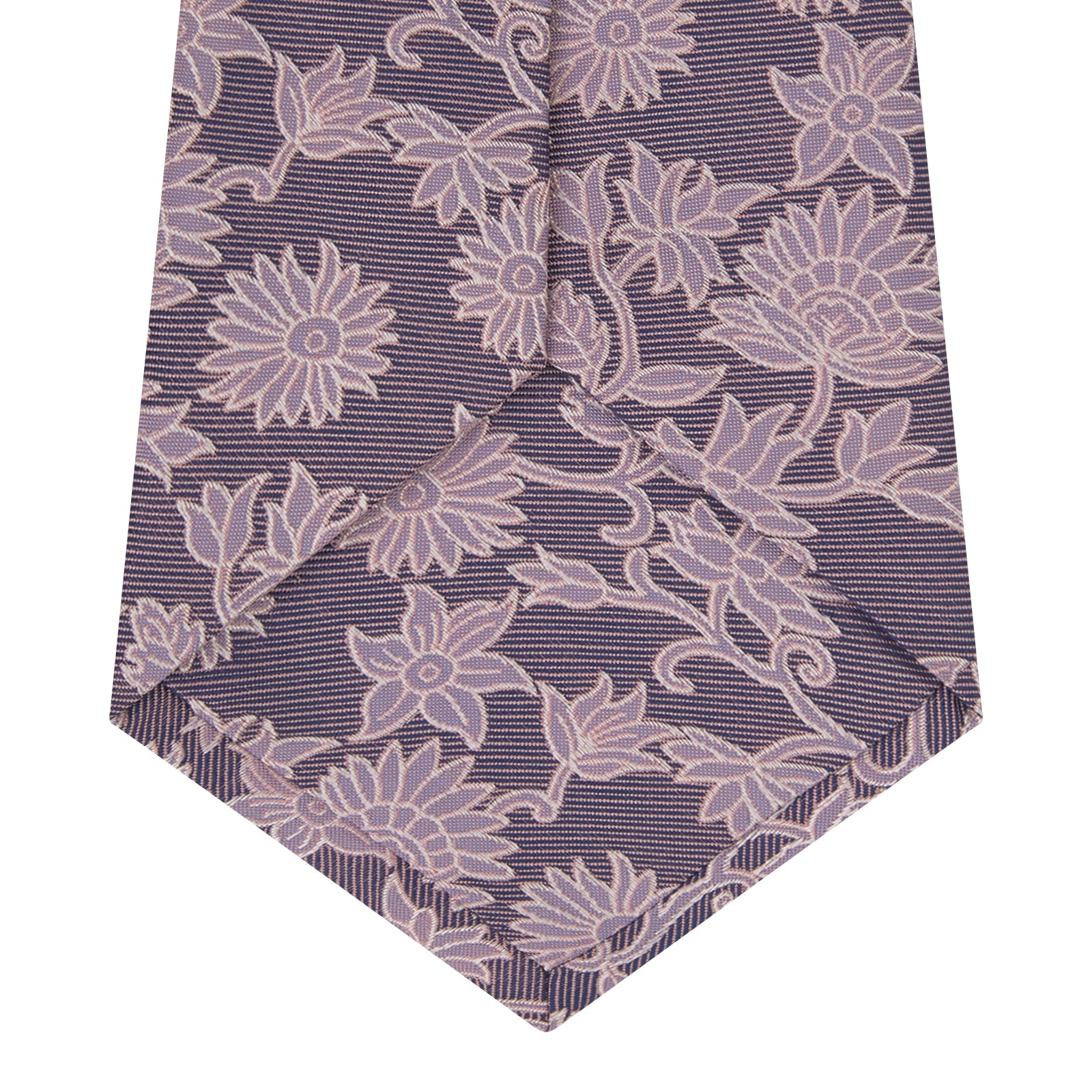 View 4 of product The Turnbull & Asser Pink Floral Occasion Silk Tie features a rolled-up purple jacquard design with a light pink floral pattern, perfect for weddings or floral events, shown on a plain white background.