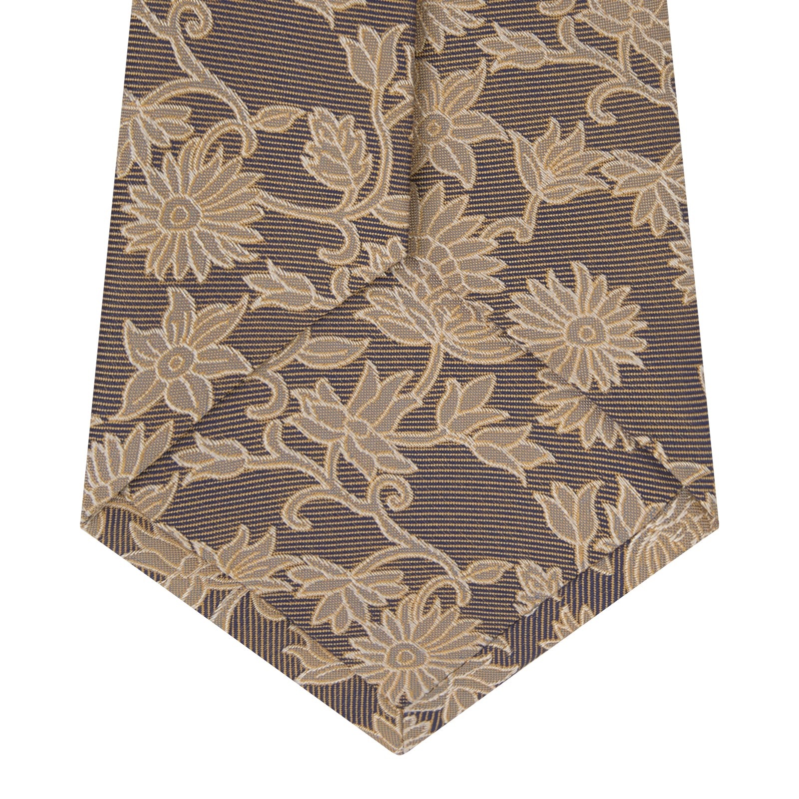 View 4 of product The Copper Floral Occasion Silk Tie by Turnbull & Asser features a gold floral jacquard pattern on brown silk, elegantly rolled on a white surface—an ideal choice for weddings.