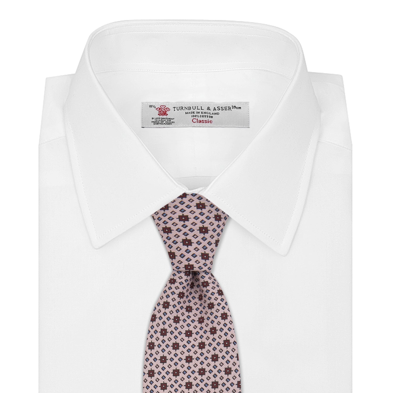 View 2 of product The Turnbull & Asser Pastel Pink Geometric Silk Tie features a small, repeating dark brown and white pattern for a mid-century look—ideal with tailored jackets. Shown rolled up on a white background.