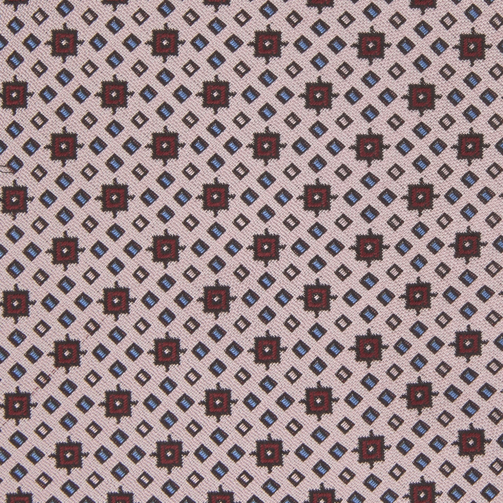 The Turnbull & Asser Pastel Pink Geometric Silk Tie features a small, repeating dark brown and white pattern for a mid-century look—ideal with tailored jackets. Shown rolled up on a white background.